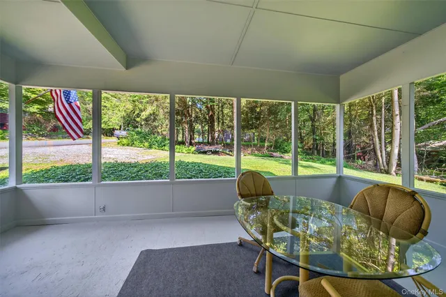 a living room with a large window and table