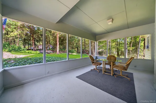 a dining room with furniture and garden view