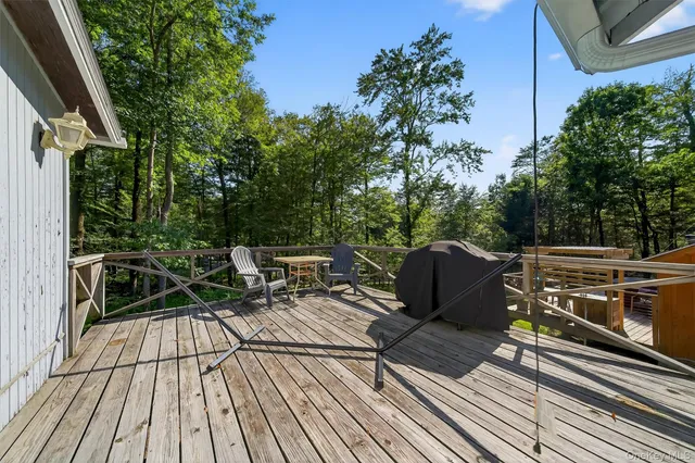 a view of balcony with wooden floor and outdoor seating