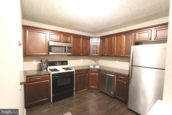 a kitchen with a sink appliances and cabinets