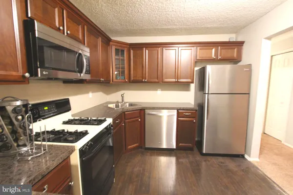 a kitchen with a refrigerator stove and microwave