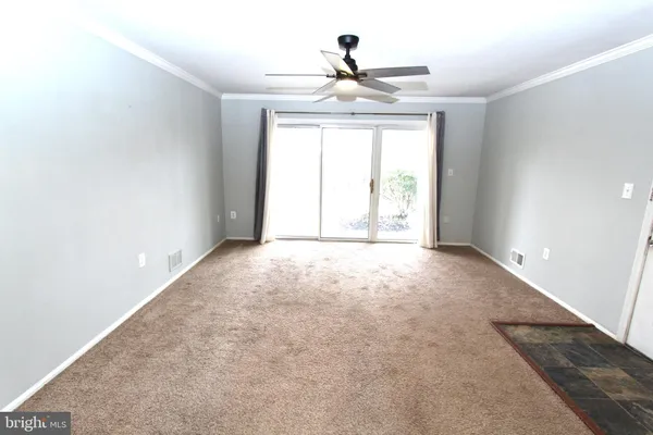 an empty room with windows and outdoor view