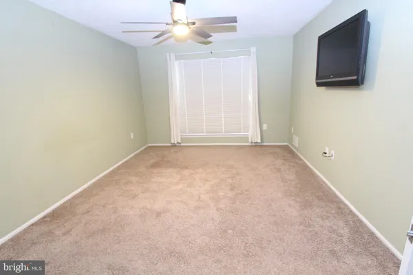 a bathroom with a toilet a a sink and a shower