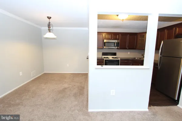 a view of a kitchen from a hallway
