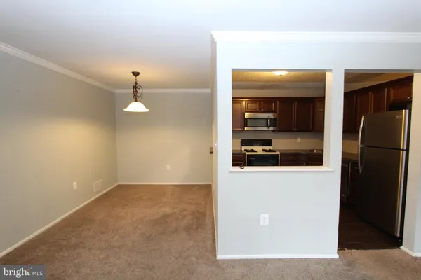 a view of a living room with a refrigerator