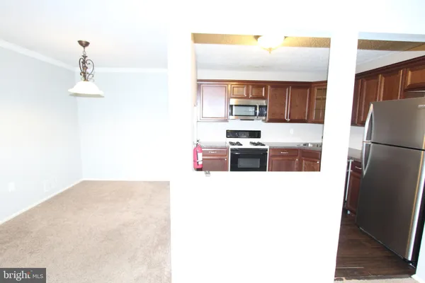 a kitchen with stainless steel appliances a refrigerator and a stove top oven