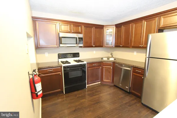 a kitchen with a sink stove and refrigerator