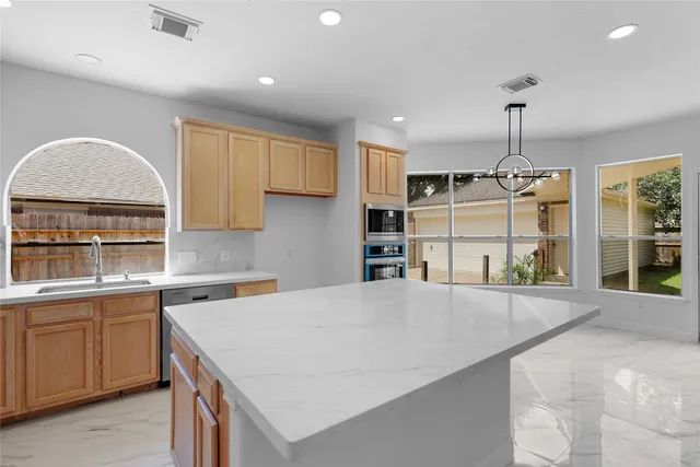 a kitchen with stainless steel appliances a stove and a cabinets