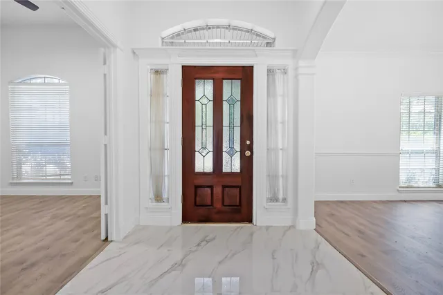 wooden floor in an empty room with a window