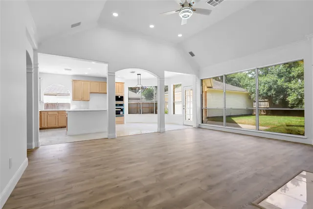 an empty room with floor to ceiling windows and an outdoor view
