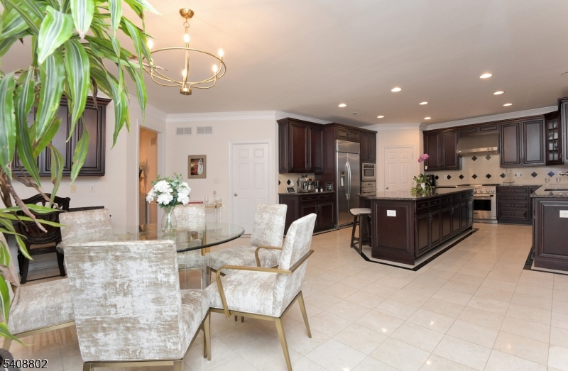 10 Raker Court Hillsborough, NJ 08844 - Photo 20 of 44 a kitchen with stainless steel appliances kitchen island granite countertop a refrigerator a stove a sink dishwasher and a dining table with wooden floor
