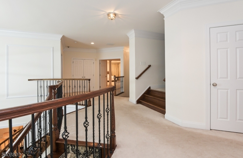 10 Raker Court Hillsborough, NJ 08844 - Photo 32 of 44 a view of staircase with lots of frames on wall and a window