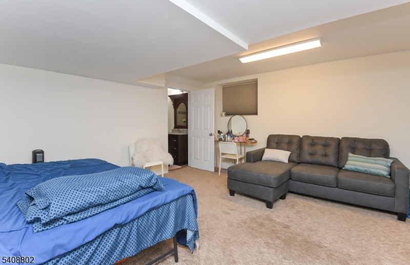 10 Raker Court Hillsborough, NJ 08844 - Photo 37 of 44 a bedroom with a bed couch and window