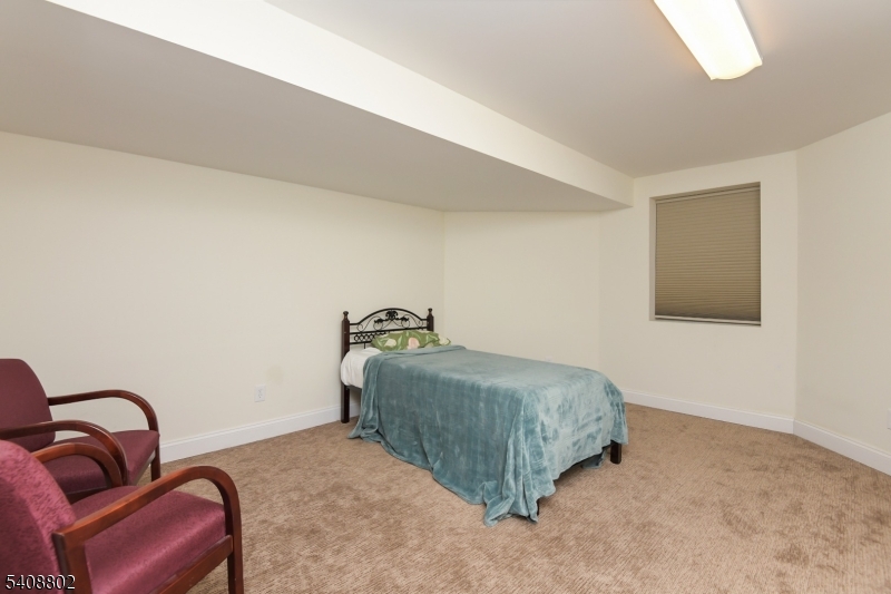 10 Raker Court Hillsborough, NJ 08844 - Photo 38 of 44 a bedroom with a bed and a couch