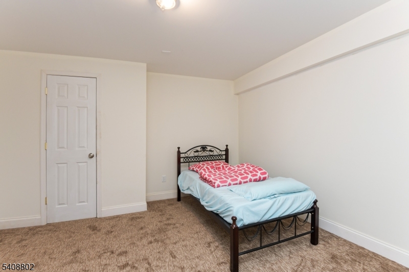 10 Raker Court Hillsborough, NJ 08844 - Photo 42 of 44 a bedroom with a bed and a table