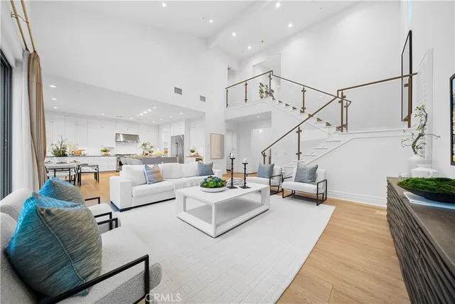 a view of a living room kitchen and a wooden floor