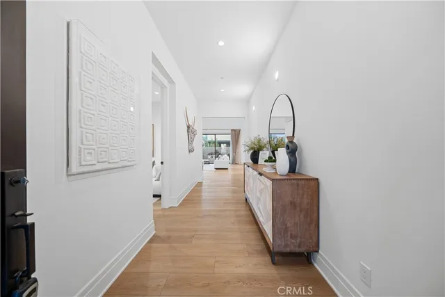 a living room with furniture and window with potted plants