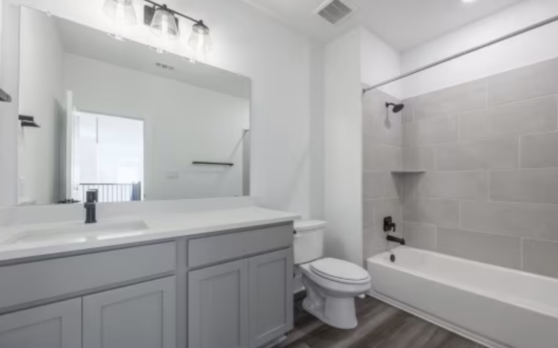 190 Prodigal Way Kyle, TX 78640 - Photo 12 of 14 a bathroom with a sink a toilet and a bathtub