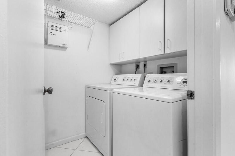 7310 Ashford Place, Unit 803 Delray Beach, FL 33446 - Photo 14 of 26 a utility room with dryer and washer