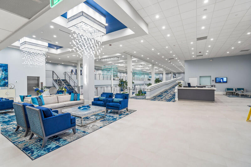 7310 Ashford Place, Unit 803 Delray Beach, FL 33446 - Photo 20 of 26 a living room with furniture and a chandelier