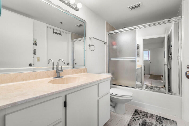 7310 Ashford Place, Unit 803 Delray Beach, FL 33446 - Photo 5 of 26 a bathroom with a sink a toilet and shower