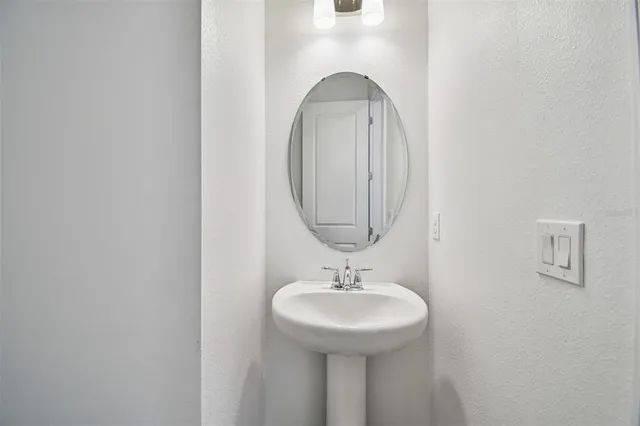 a bathroom with a granite countertop sink a toilet and a bathtub