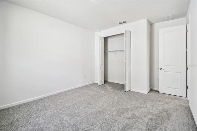 a view of a house with a yard and potted plants