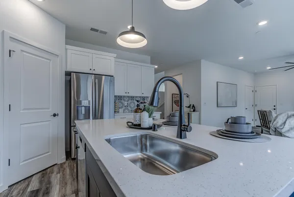 a kitchen with stainless steel appliances a sink and a refrigerator