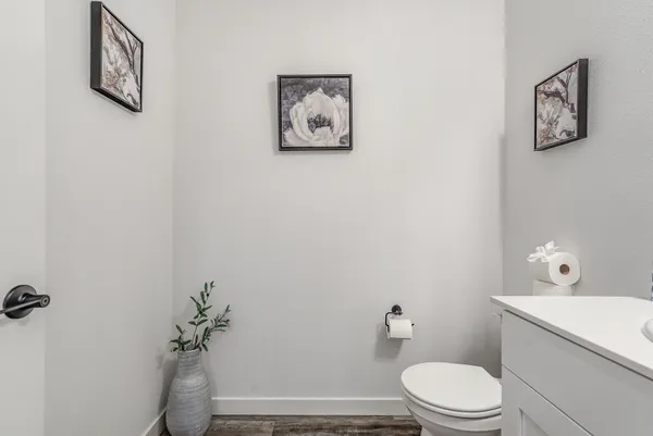 a white toilet sitting next to a bathroom sink