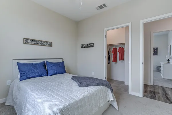 a bedroom with a large bed and a closet