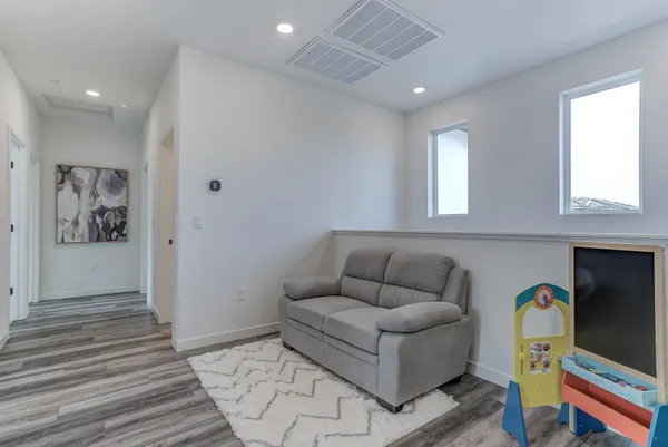 a living room with furniture and a wooden floor