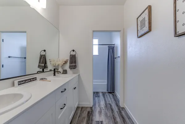 a bathroom with a double vanity sink and mirror