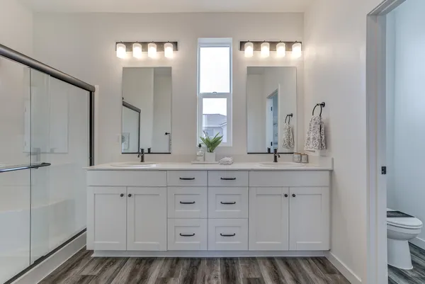 a bathroom with double sink and a mirror