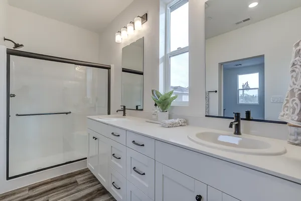 a bathroom with a double vanity sink and mirror