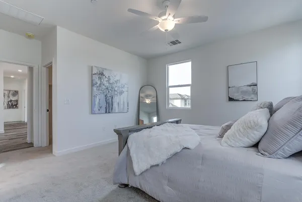 a bedroom with a bed and a chandelier