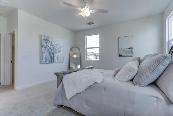 a bedroom with a bed and a chandelier