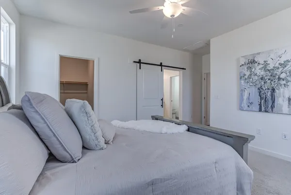 a bed room with a bed and a chandelier