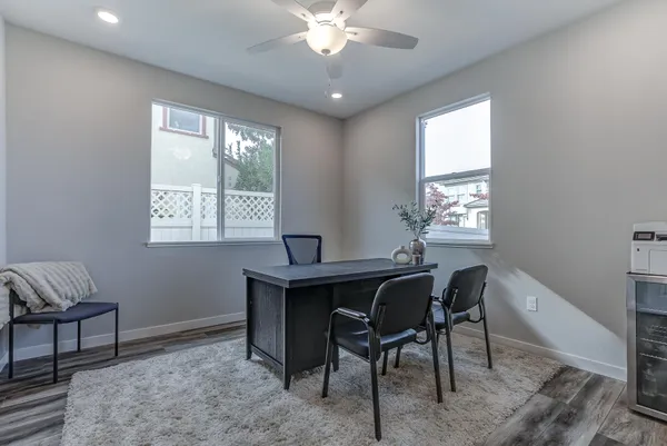 a view of a workspace with furniture and a window