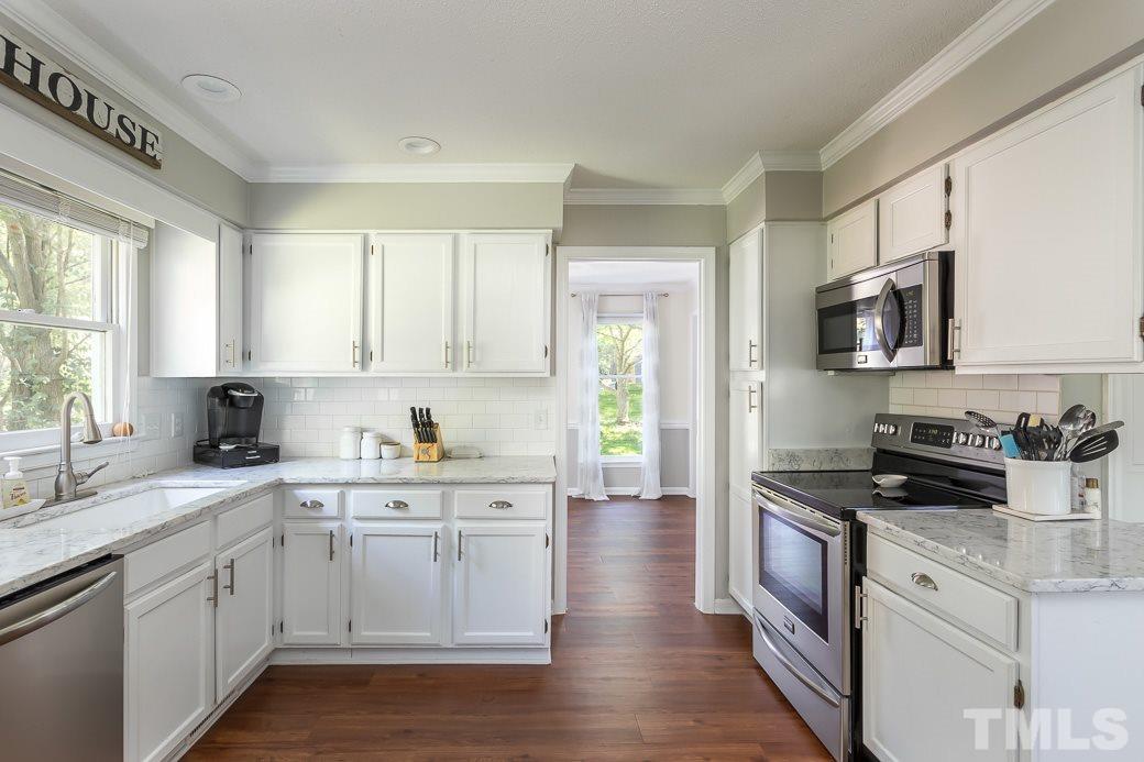3 Hitching Rack Court Durham, NC 27713 - Photo 2 of 9 a kitchen with granite countertop white cabinets a sink a window and stainless steel appliances