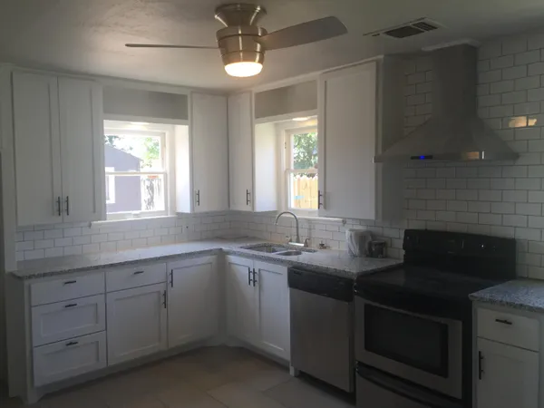 a kitchen with a sink stove and cabinets