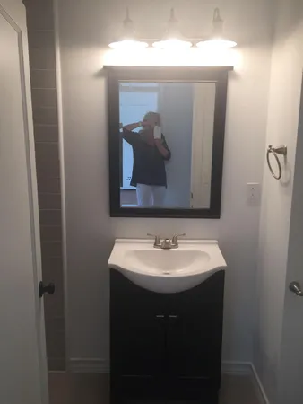 a bathroom with a sink and mirror
