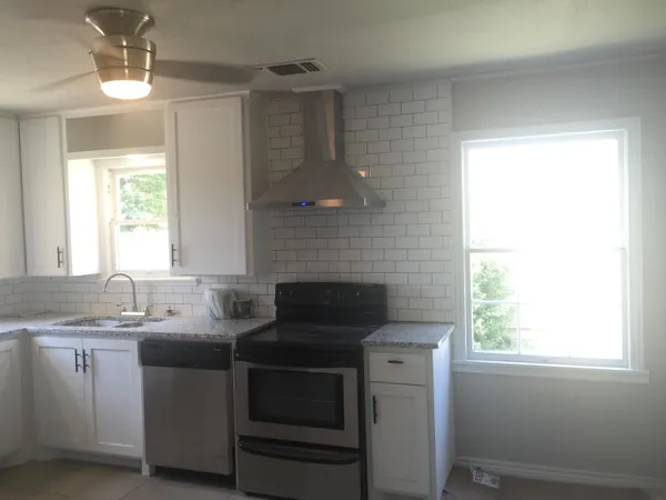a kitchen with a sink stove and microwave
