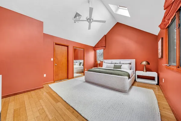 a bedroom with a bed and lamp next to a window