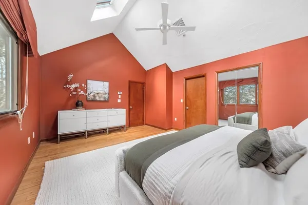 a bedroom with a large bed and a chandelier