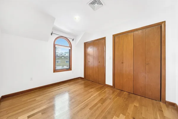 an empty room with windows and closet