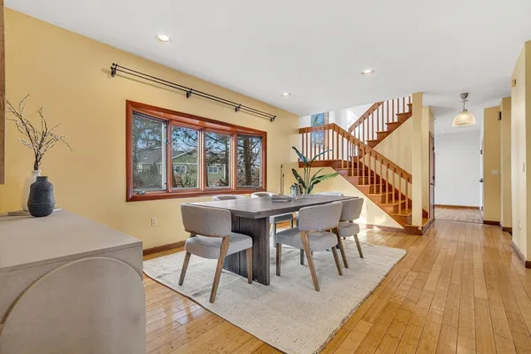 a dining room with furniture and wooden floor