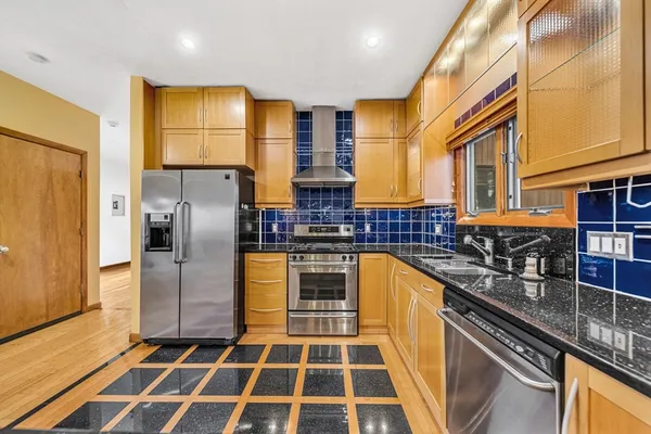 a kitchen with stainless steel appliances granite countertop a stove and a granite counter tops