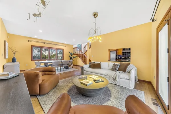 a living room with furniture and a chandelier