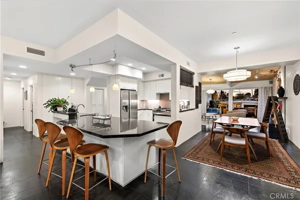 a dining room with furniture and wooden floor