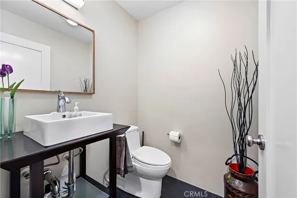 a bathroom with a sink a toilet and a mirror